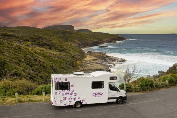 Chill'd Big Kahuna Motorhome parked on cliffside road overlooking ocean