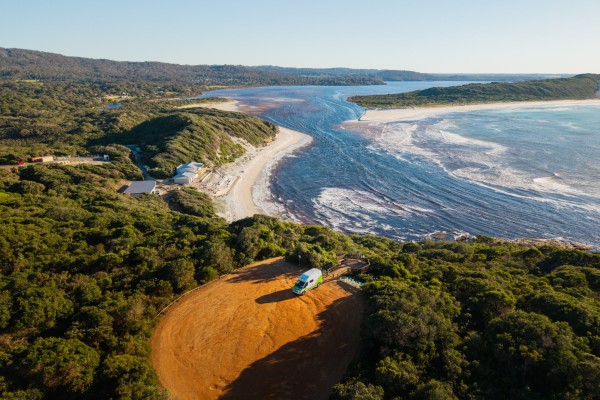 JUCY condo parked on dirt car park overlooking ocean view