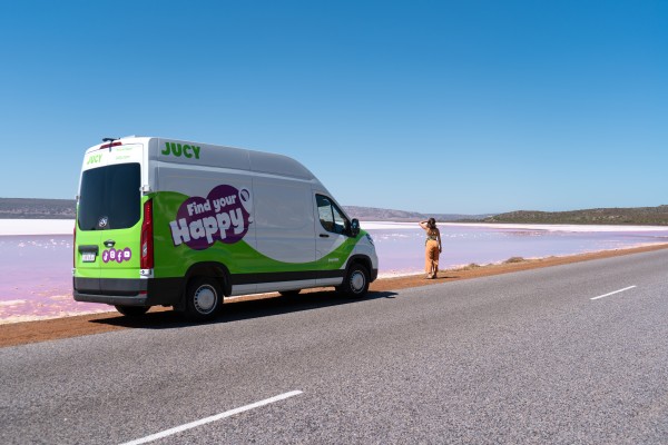 JUCY Coaster campervan hire parked next to lake in WA