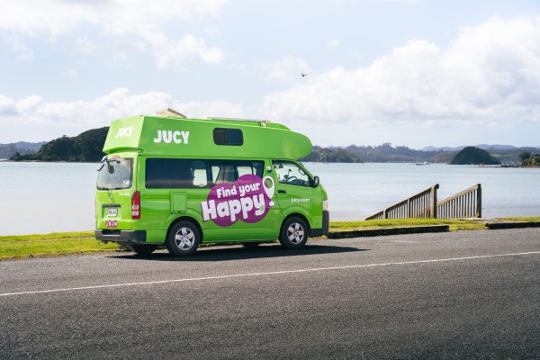 JUCY Condo Campervan hire parked next to lake