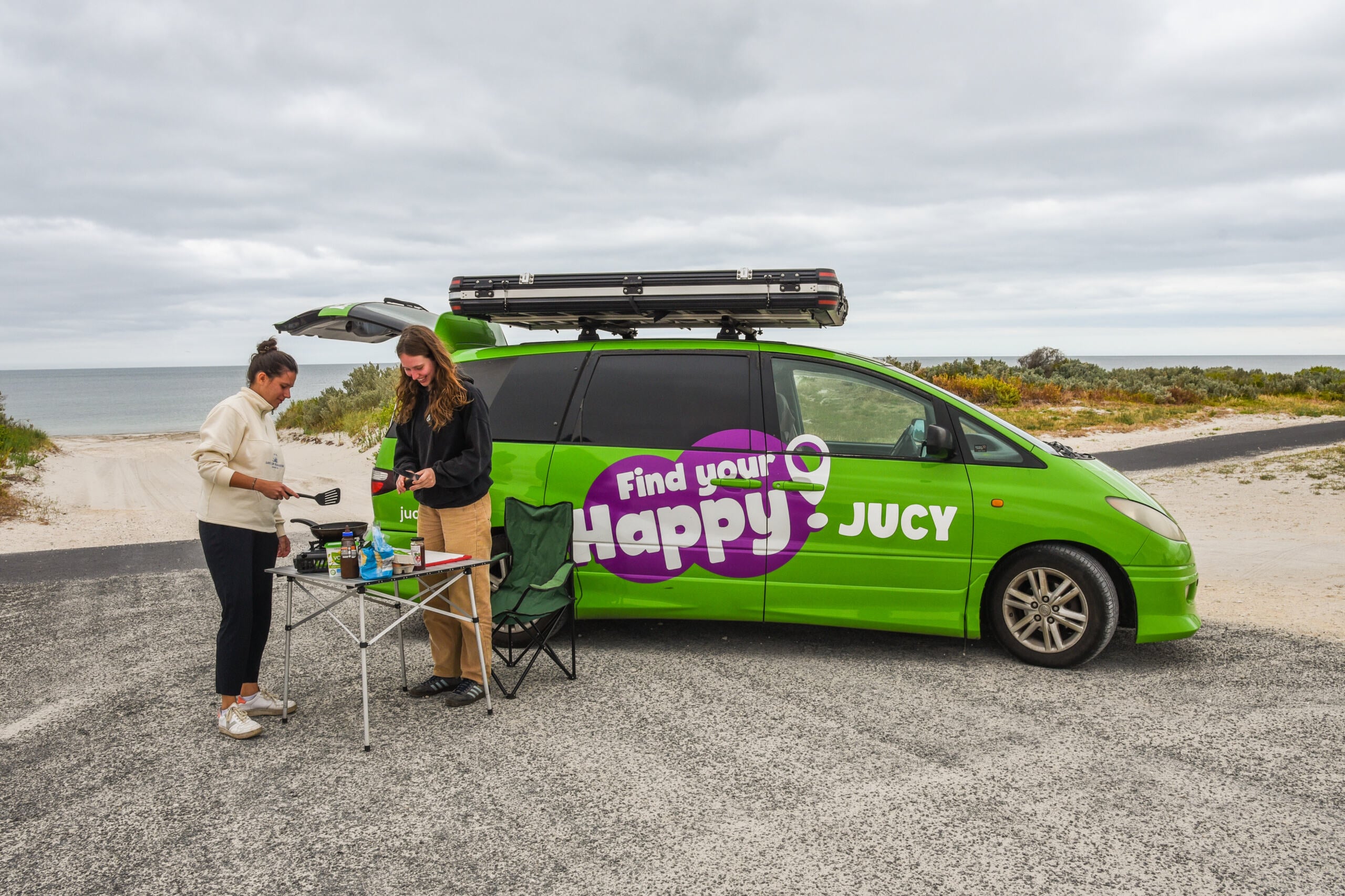2 girls with a Crib Plus Campervan on beach