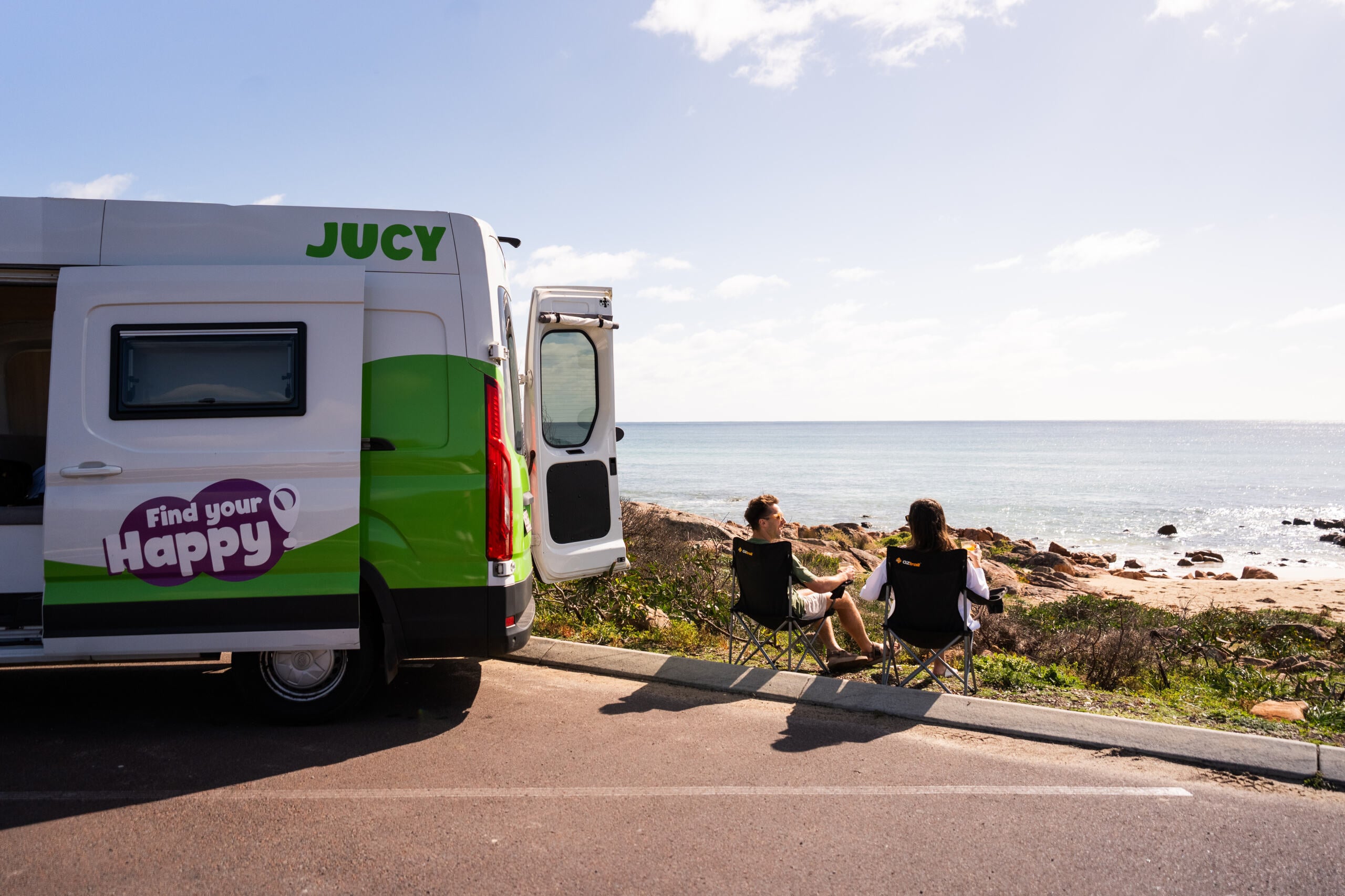 JUCY Coaster Campervan on Beach with Couple