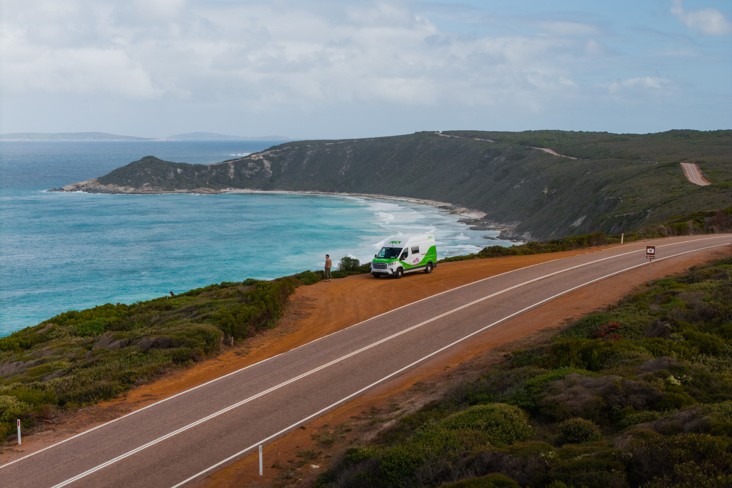 Coaster Campervan Hire Australia parked on coastal cliffside