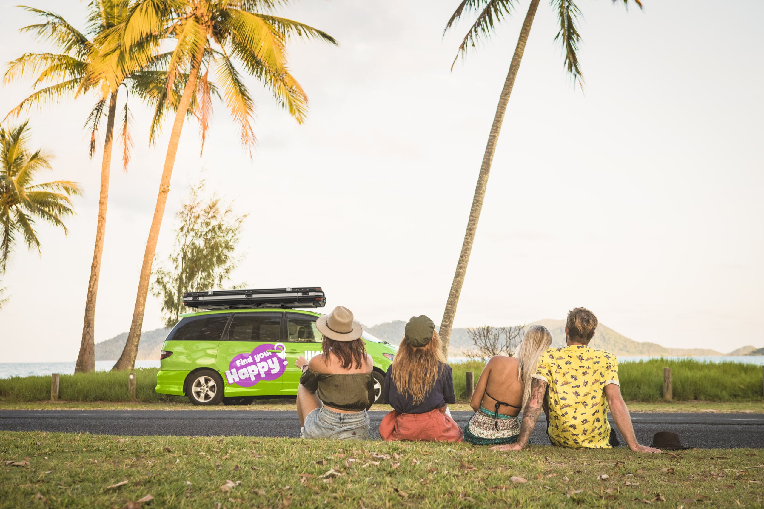 Group of mates sitting on grass with JUCY crib plus