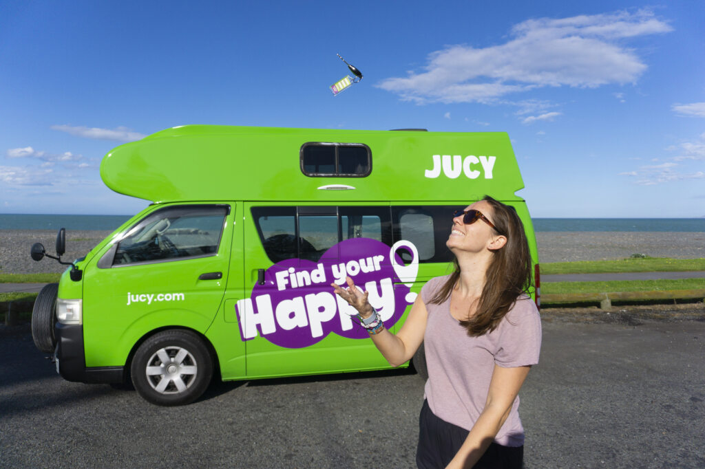 Happy lady holding condo campervan hire keys