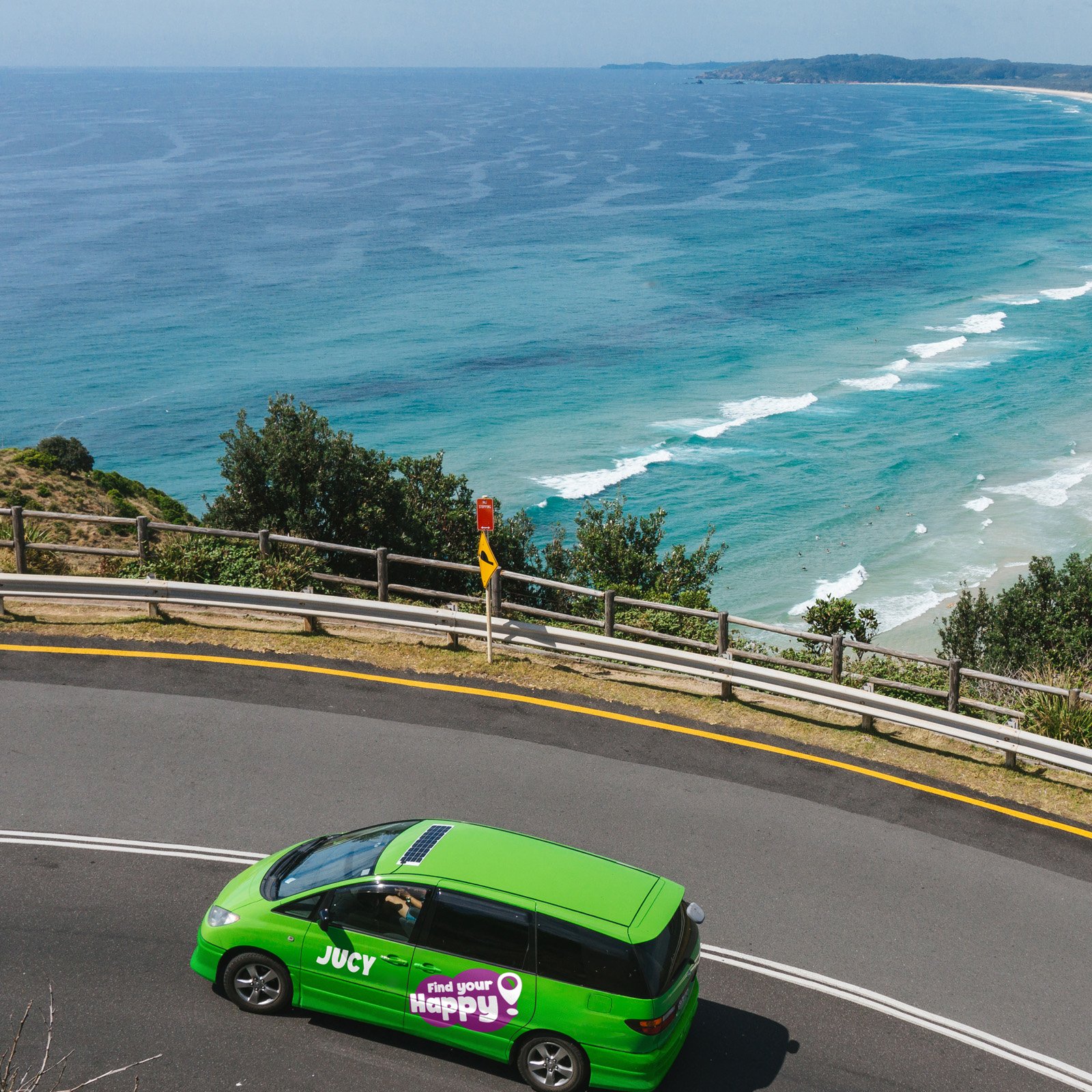 JUCY Crib campervan driving on coastal road near Sydney