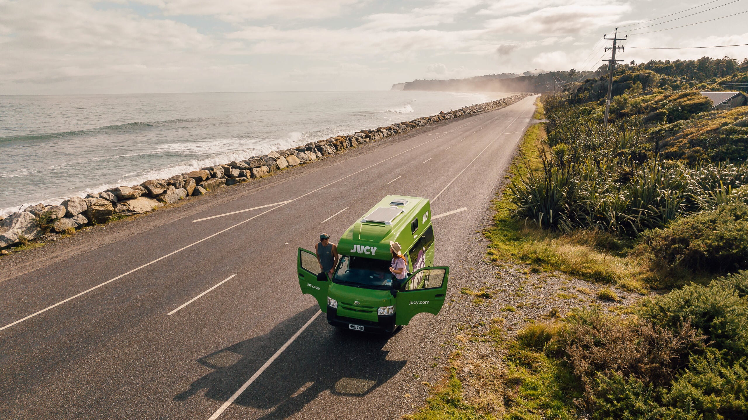 Couple Parked JUCY Condo on Beach-side road 