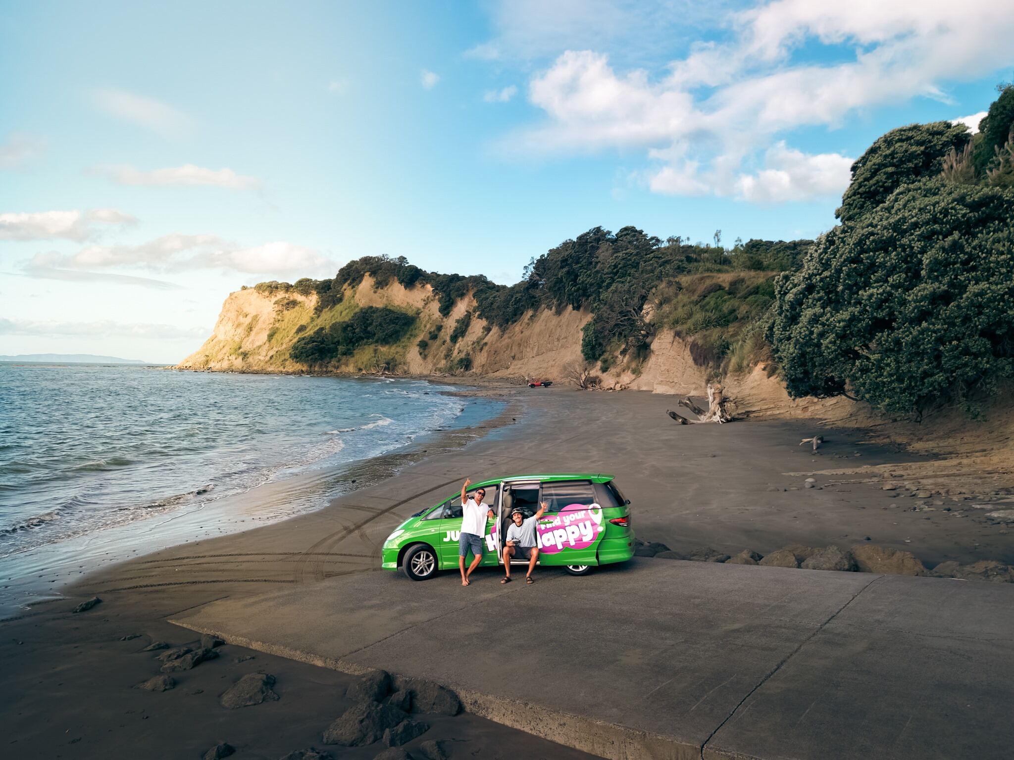 2 Friends Parked with JUCY Crib Campervan on Beach