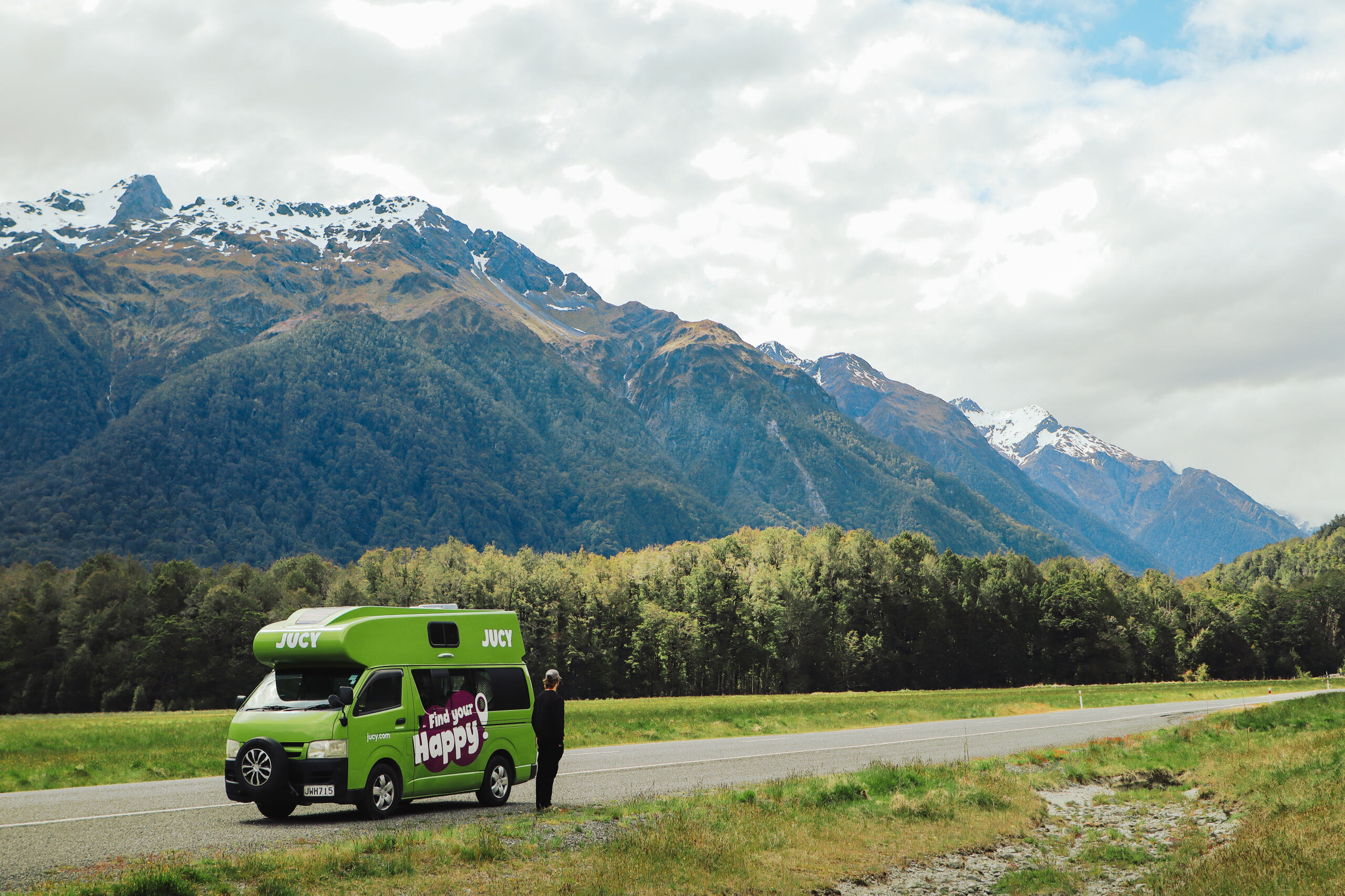 JUCY Condo parked on roadside with snow-capped mountain backdrop