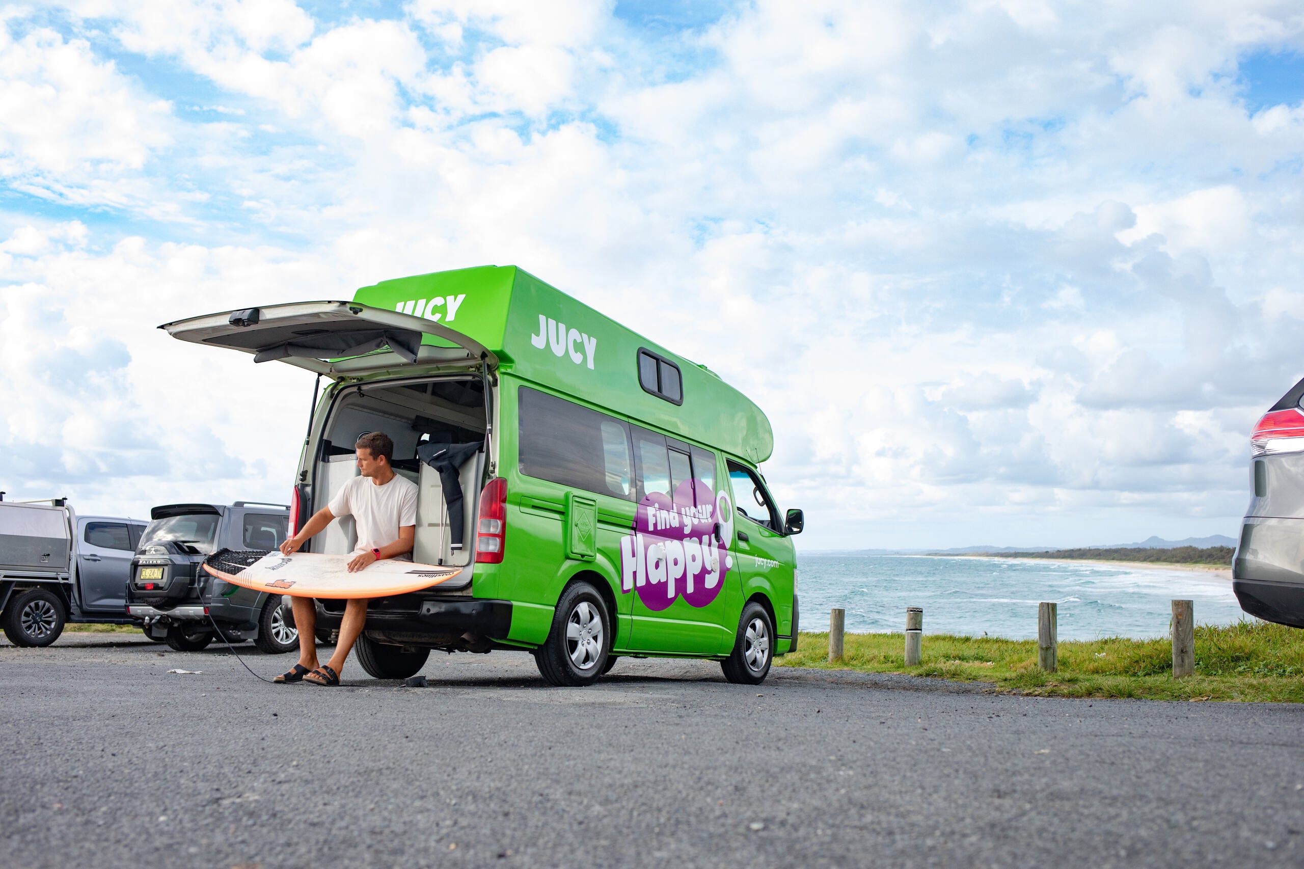 Condo Campervan with Surfer Waxing his Board