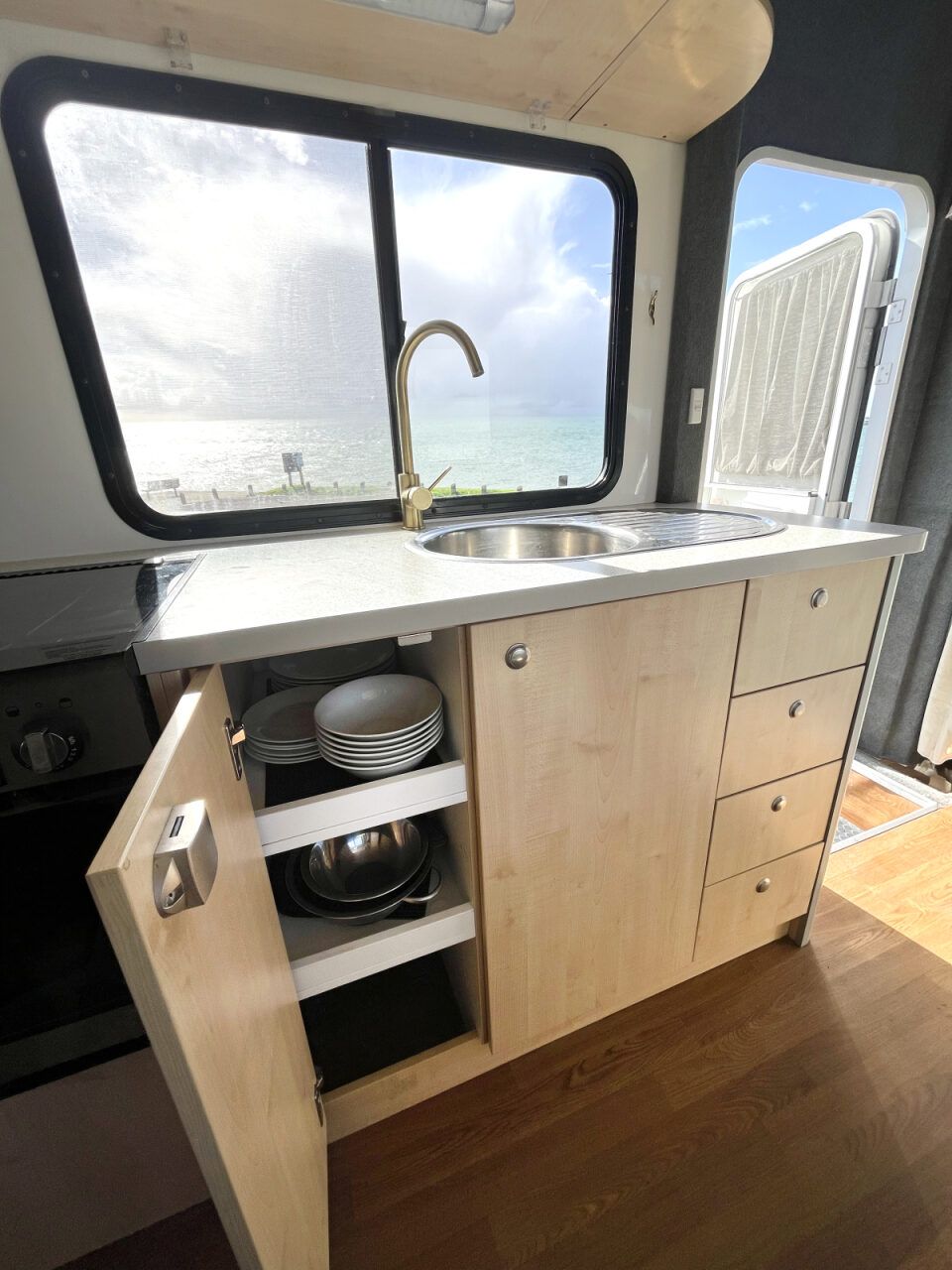 Kitchen and kitchenware - Road-trip ready kitchen kit with utensils, pots, pans, plates, and a mini sink with fresh water in the kitchen.