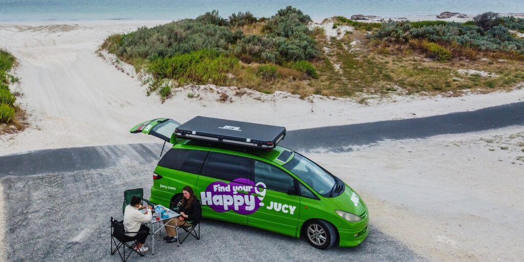 Crib Plus Campervan On Australian Beach With Camping Table