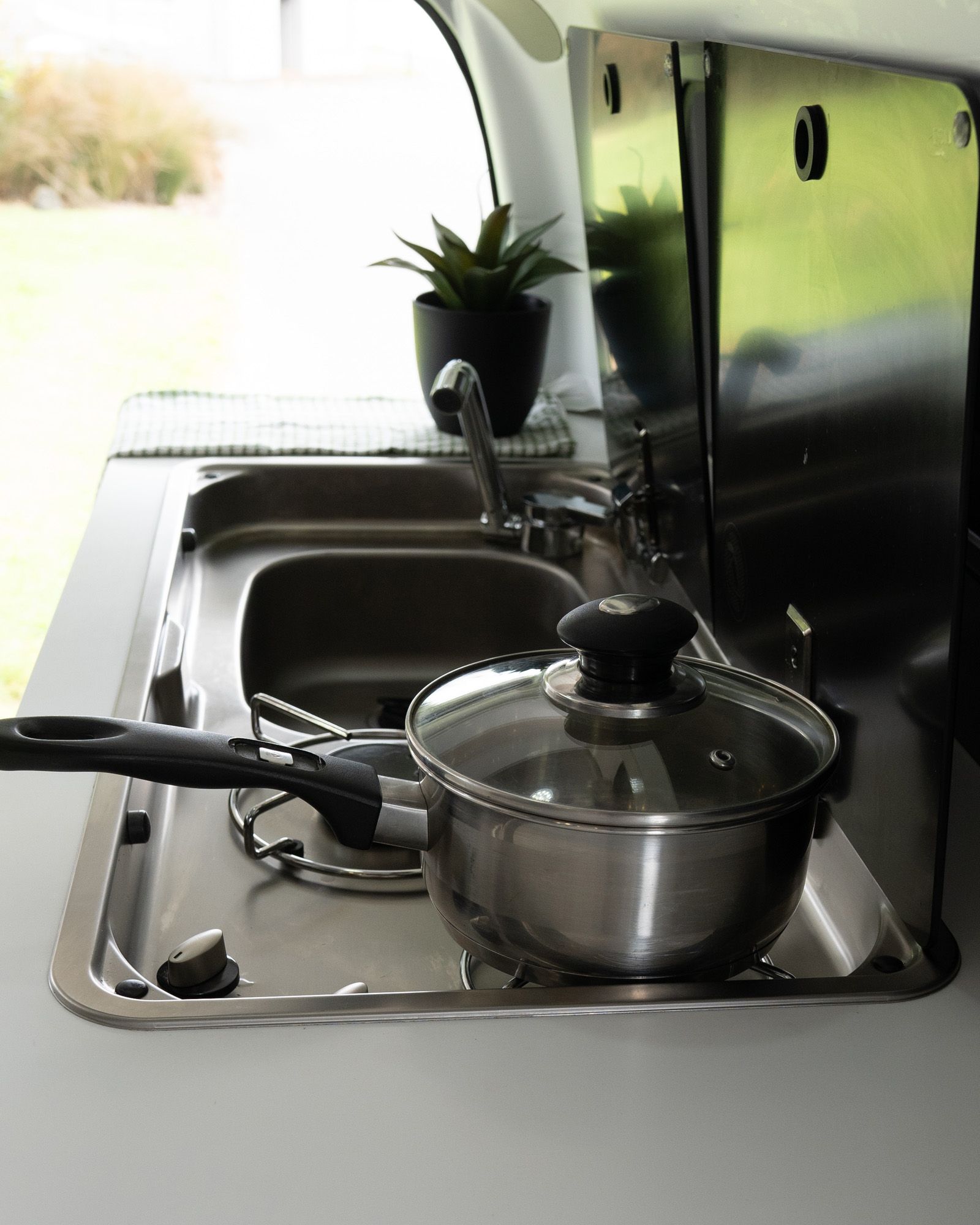 Kitchen and kitchenware - Road Trip ready kitchen kit with utensils, pots, pans, plates, and a mini sink with fresh water in the kitchen.