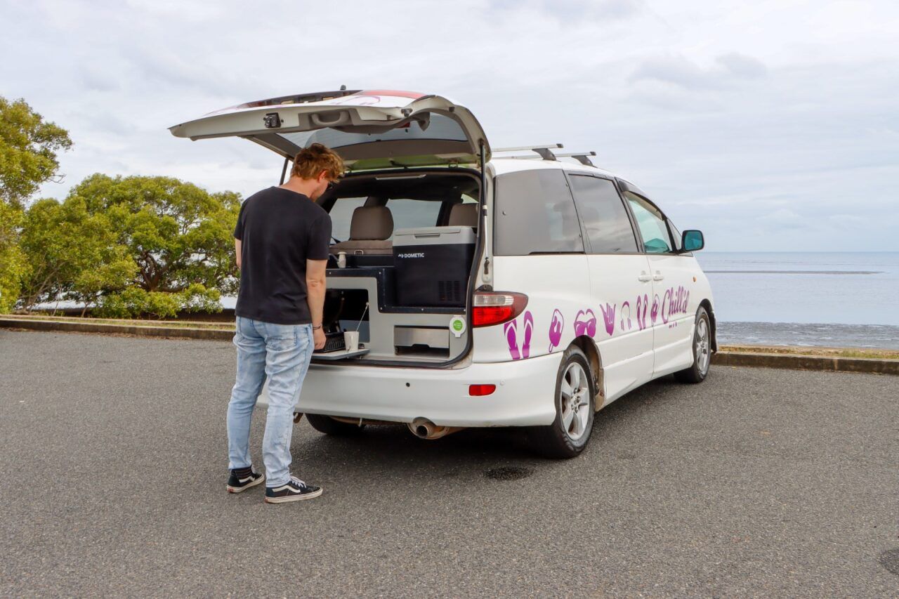 Cloudbreak Campervan with man using stovetop and kitchen