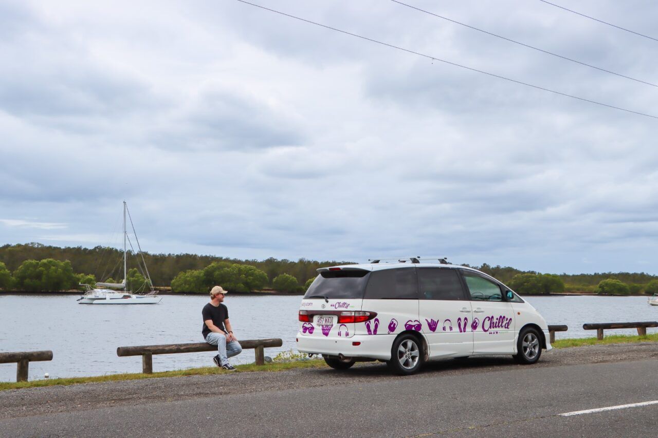 Cloudbreak campervan parked next to a river with man outside