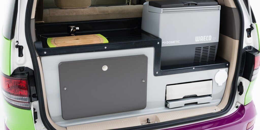 Close-up of the Rear Of Crib Plus Campervan Showcasing Kitchen and Fridge