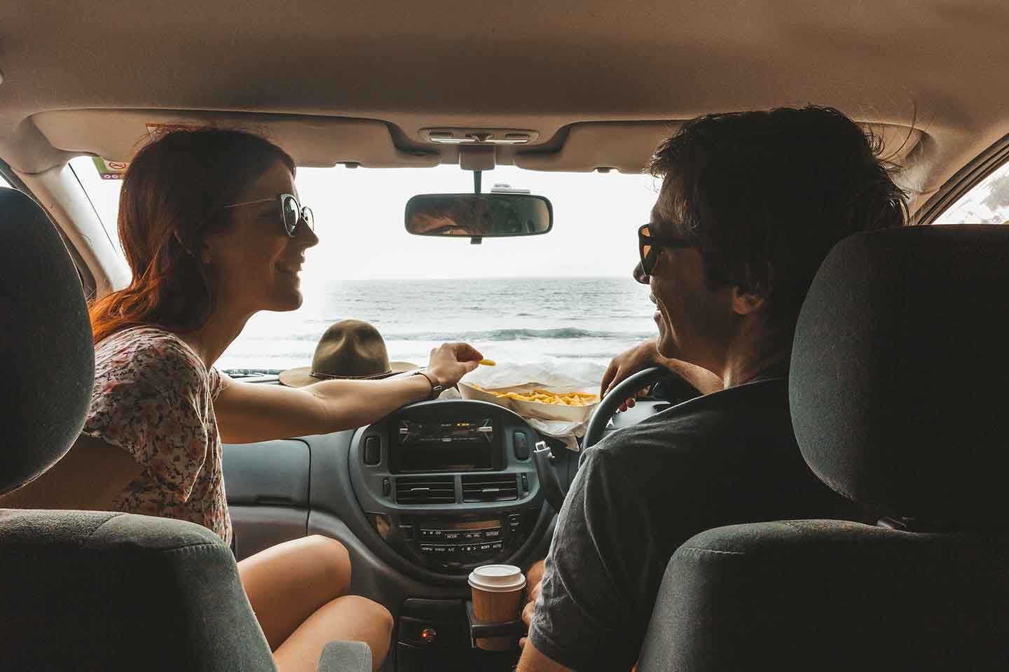 A Couple Sitting in the Front Seats of Crib Plus Campervan and Enjoying Their Road trip